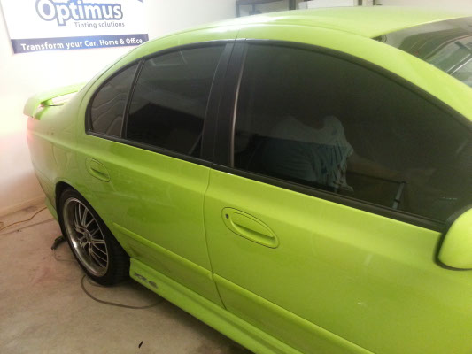 car window tinting installed on a green colour Ford Falcon sedan side view