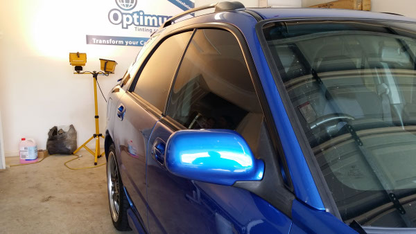 close up side view blue colour Subaru Impreza car with UV blocking window film