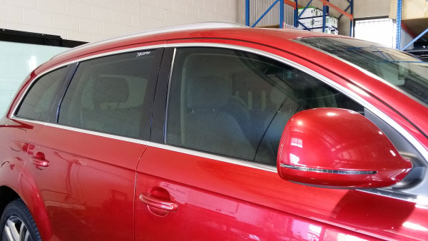 close up side view of Audi Q7 luxury SUV tinted with darkest legal film