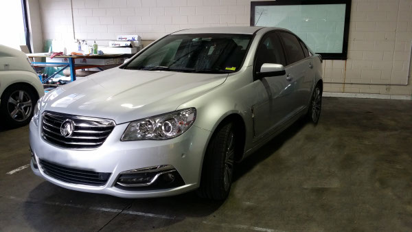 front view silver Holden Commodore sedan front windscreen glass tinted by Optimus Tinting Solutions Brisbane