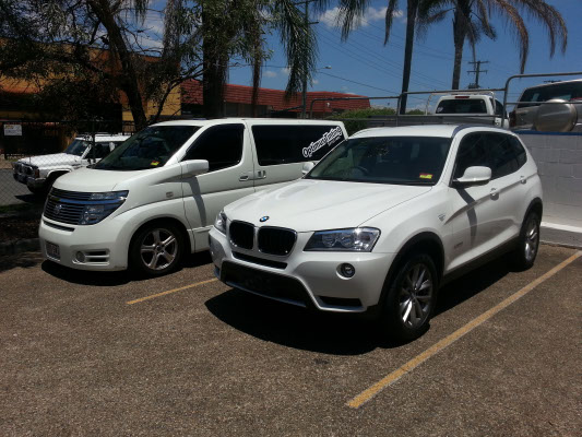 front view white colour BMW X3 SUV automobile electric window tint