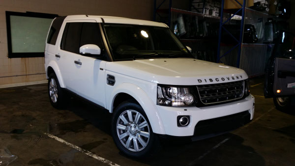 front view white colour Land Rover Discovery with car windows tinted by Optimus Tinting Solutions