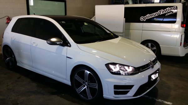 front view white colour Volkswagen Golf car windows tinted with darkest legal film in Australia