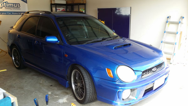 full front view blue colour Subaru Impreza car with windows tinted professionally