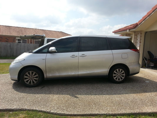 full side view grey colour Toyota Tarago GLI van with tinted film on car windows