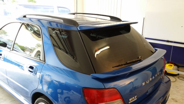 rear view blue colour Subaru Impreza car with ultraviolet UV radiation blocking window film