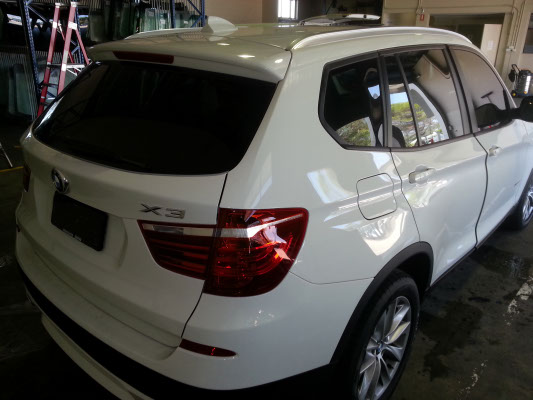 rear view white colour BMW X3 SUV automobile electric window tint