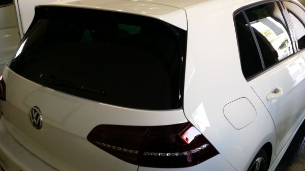 rear view white colour Volkswagen Golf car windows tinted with darkest legal tint in Australia