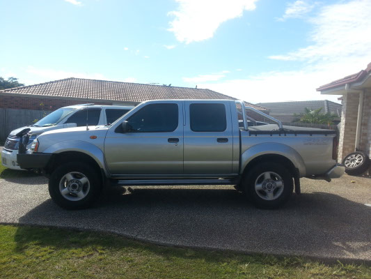 side view of grey colour Nissan Navara Ute after car windows tinted