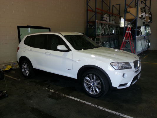 side view white colour BMW X3 SUV automobile electric window tint