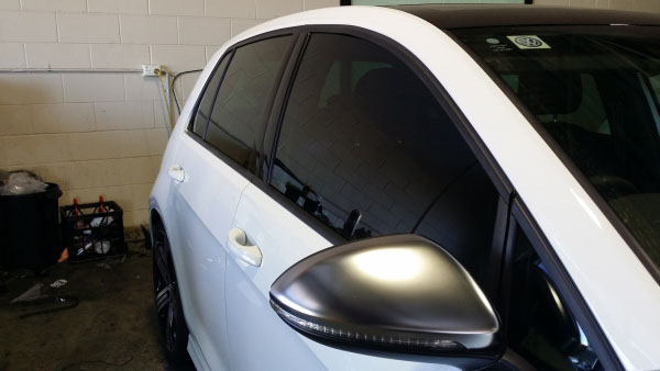 side view white colour Volkswagen Golf car windows tinted with darkest legal film in Australia