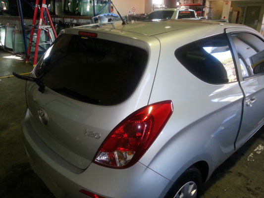 silver colour Hyundai i20 mini hatchback rear view rear windshield tinted