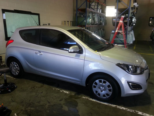 silver colour Hyundai i20 mini hatchback side view windows tinted